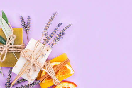 Organic natural set made of olive, lavender and orange pieces of soap packed with dried lavender and olive herbs and orange slice. Organic spa set.の写真素材