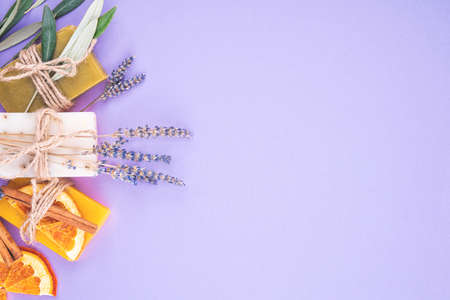 Organic natural set made of olive, lavender and orange pieces of soap packed with dried lavender and olive herbs and orange slice. Organic spa set.の写真素材