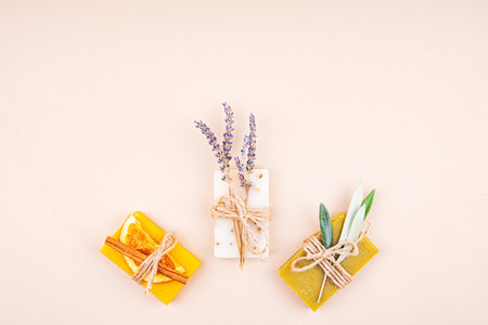 Organic natural set made of olive, lavender and orange pieces of soap packed with dried lavender and olive herbs and orange slice. Organic spa set.の写真素材