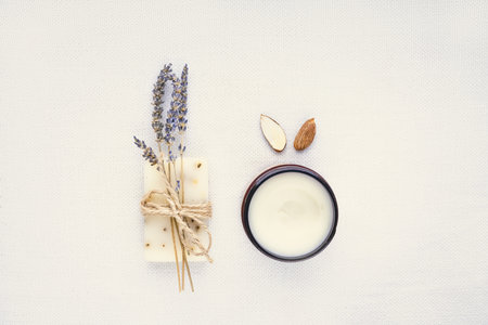 Piece of natural organic lavender packed with dried lavender and almond oil cream  on light linen background. Organic spa set.の写真素材