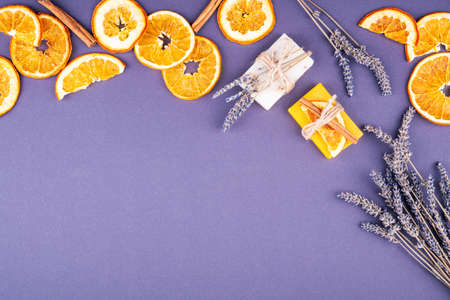 Organic natural set made of lavender and orange pieces of soap packed with dried lavender, orange slice and cinnamon stick. Organic spa set.の写真素材