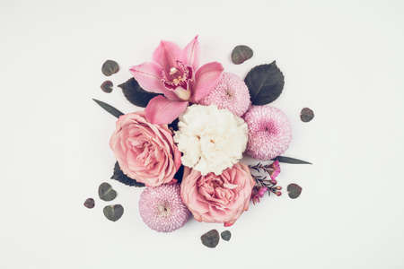 Flowers bouquet  made of roses, chrisantemum, carnation and baby eucalyptus leaves on light background. For holiday project.の写真素材