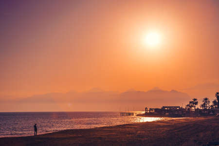 Beautiful sunset on the beach of Mediterranean sea, Antalya, Turkey.の写真素材