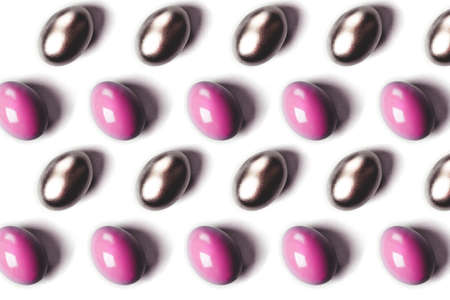 Pink and golden colored easter eggs on blue background. Easter concept.の写真素材