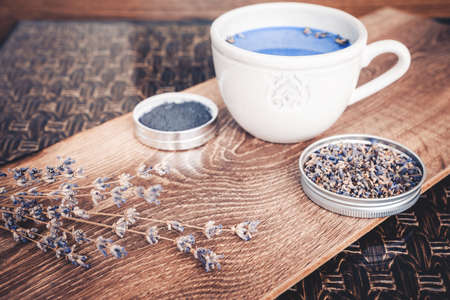 Cup of lavender matcha tea, lavender flower branch and lavender powder. Antioxidante beverage.の写真素材