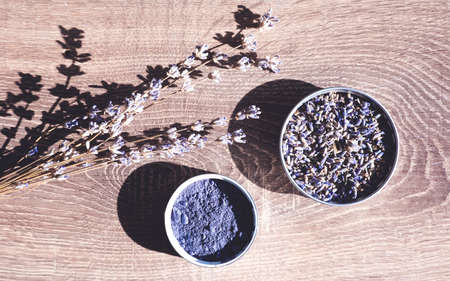 Cosmetic ingredients set made of organic lavender branches, lavender powder on wooden background.の写真素材