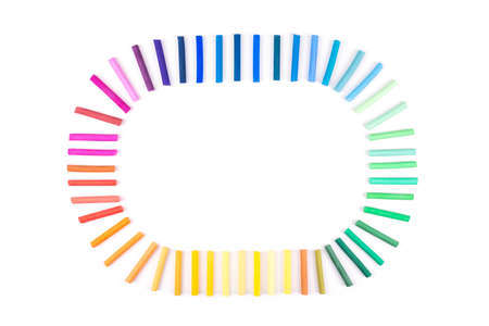 Rainbow bright colored pastel penciles on isolated white. Art education concept.