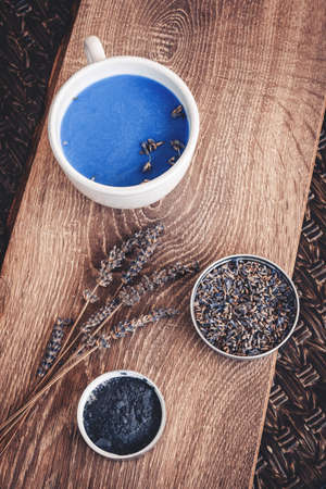 Cup of lavender matcha tea, lavender flower branch and lavender powder. Antioxidante beverage.の写真素材