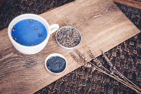 Cup of lavender matcha tea, lavender flower branch and lavender powder. Antioxidante beverage.