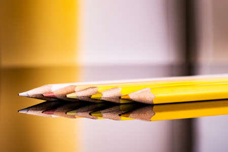 Yellow bright colored  penciles on isolated black. Art education concept.の写真素材