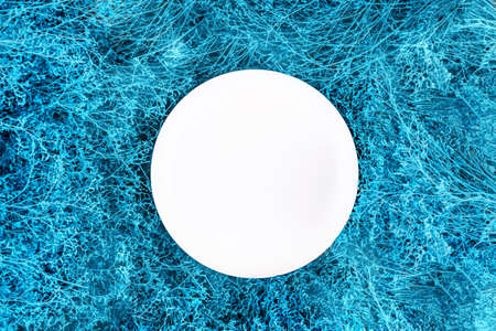 Abstract sea wave colored decorating plant bush background and white plate. Summer abstract background.の写真素材