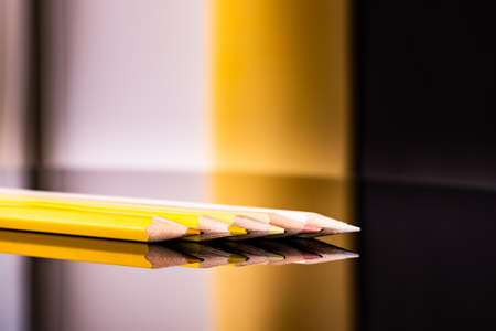 Yellow bright colored  penciles on isolated black. Art education concept.の写真素材