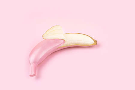 Modern pattern pop flat lay style made of  pink colored opened bananas on pink background. Festive or summer concept.の写真素材