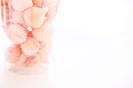 Soft pink color of mini marshmallows dessert in transparent plastic glass on isolated whiteの写真素材