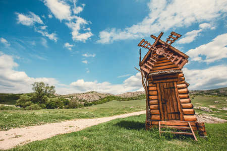 Landscape scenery of wooden windmill on a hill, touristic sightsing.