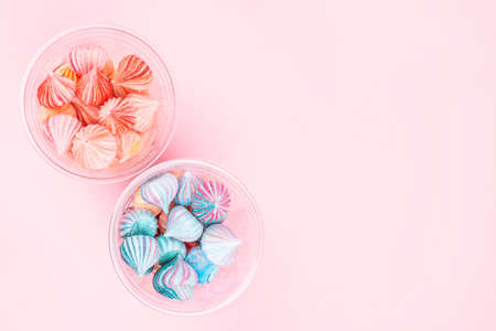 Soft pink and blue  color mini marshmallows dessert in plastic glasses top view, flat lay style. Concept for holiday party card.の写真素材