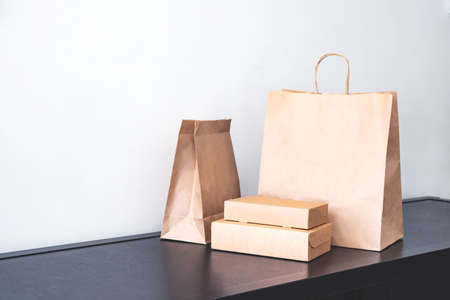 Craft paper eco-friendly  bags and boxes for shopping or lunch set. Concept of eco-friendly...