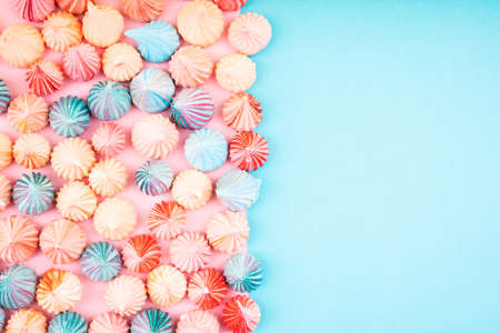 Soft pink and blue color of mini marshmallows dessert top view, flat lay style. Concept for holiday party card.の写真素材