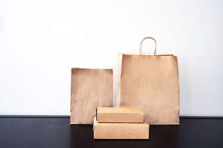 Craft paper eco-friendly  bags and boxes for shopping or lunch set. Concept of eco-friendly consumption.の写真素材