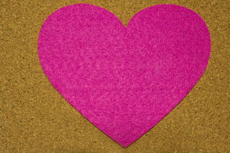 Cork background decorated with pink heart at center for mothers day messageの写真素材