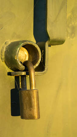 Golden padlock has not been opened, as evidenced by the spider netsの写真素材