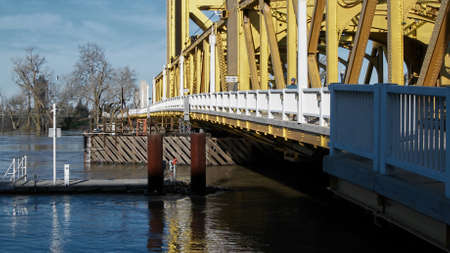 Sacramento, California, U.S.A. 12 February 2017. The water level of the Sacramento River is high, almost reaching the Tower Bridge and has partly flooded the River Walk Park in West Sacramento.のeditorial素材