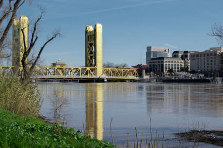 West Sacramento, California, U.S.A. 12 February 2017. Sacramento Tower Bridge viewed from the River Walk trail near the Raley Field, showing the high water levels of the Sacramento River after the heavy rainsのeditorial素材