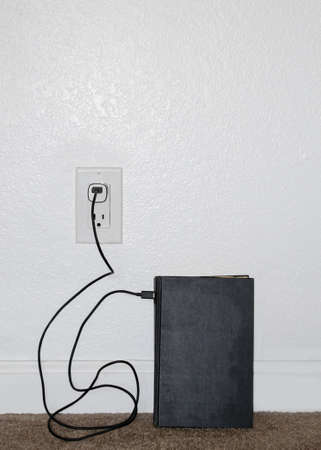Abstract nonsense composition portraying a vintage, hard-bound book on a carpet floor leaning...