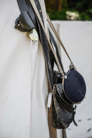 Canteen, leather backpack, leather belt and US badge hanging at the entrance of a civil war era...