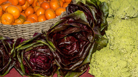 Romanesco broccoli, Red Butter Lettuce and cutties arranged for sale in a farmers market