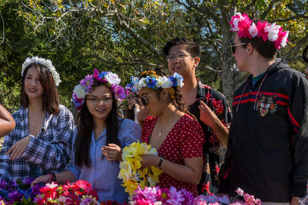 Davis, CA - April 21, 2018. Students with flower crowns in a booth during UC Davis annual Picnic day. During picnic day the university showcases its departments. There are family activities all over campus focusing on education.のeditorial素材