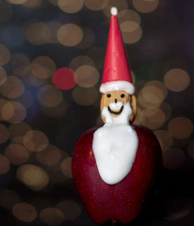 Hand-made home craft  Santa Claus Christmas Ornament with a beautiful bokeh on tan background- ideal craft for children during the holliday seasonの写真素材