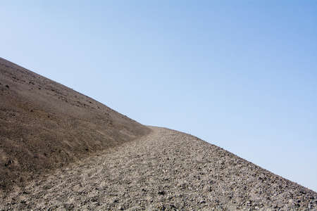 Detail of the Cinder Cone trail, Lassen Volcanic National Park, when it curves, on a smoky day, featuring plenty of copyspaceの写真素材