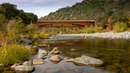 Side view of the bridgeport Covered Bridge at South Yuba River in California, USA, featuring the fall colors in the river. This bridge has the longest clear span of any surviving covered bridge in the worldのeditorial素材