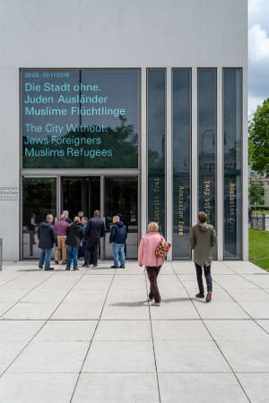 Munich, Bavaria, Germany - May 18, 2019. Tourists walking towards the the entrance of N-S...
