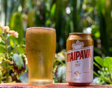 Petropolis, Rio de Janeiro, Brazil- September 8, 2015: A bottle Itaipava beer against tropical garden., very cold and ready to drinkのeditorial素材