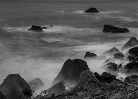 Long exposure of the surf from Rocky point, Patricks Point State Park, Northern California, USA, in black and white, featuring lots of copy-spaceの写真素材