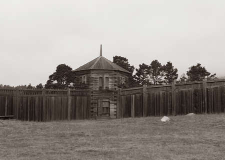 Old Building watch post Fort Ross state park, a Russian Fort, on a foggy day, typical of the Sonoma Coast, California, USA in black and white with a sepia toneのeditorial素材