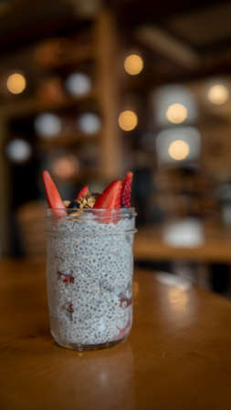 Vegan Tapioca and strawberries in a restaurant setting viewed from the side with lots of copy-spaceの写真素材