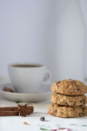 Oatmeal and Raisins Cookies  on white background and decorated with spices, served with coffee and a...
