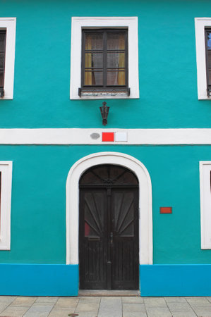 Ceske Budejovice, Czech Republic - July 18, 2011: Facade of a blue painted house with dark door and windowsのeditorial素材