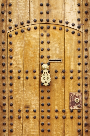 Wooden door with arab style doorknob in Marrakech, Moroccoの写真素材