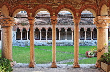 Columns and arches in the medieval cloister of Saint Zeno. Verona, Italy - HDRのeditorial素材