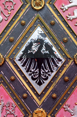 Detailed view of a wooden door with emblemsの写真素材
