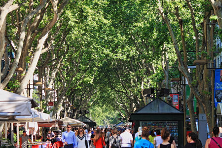 BARCELONA, SPAIN - MAY 17, 2017: Crowd walking on La Rambla tree lined area. The tourist popular crowded pedestrian zone of Las Ramblasのeditorial素材