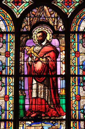 Stained glass window with a saint