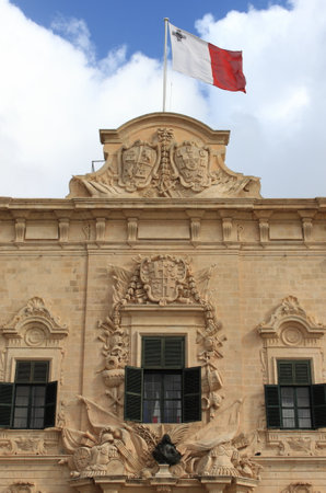 Flag of Malta. The coat of arms of Castille and Leon on top of the Auberge de Castille in Vallettaのeditorial素材