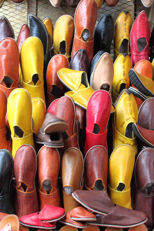 Leather moroccan slippers for sale in a market stallの写真素材