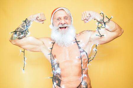 Happy fit santa claus equiped with white christmas lights