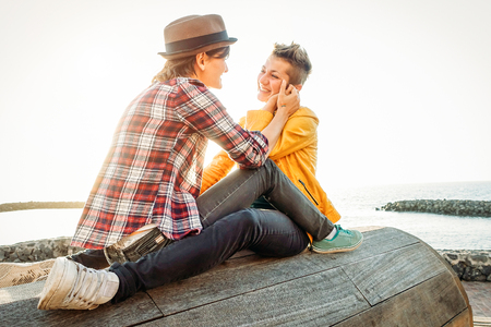 Happy gay couple in romantic date on the beach - Young lesbians having a tender moment outdoor - Lgbt, bisexuality, relationhsip lifestyle conceptの写真素材